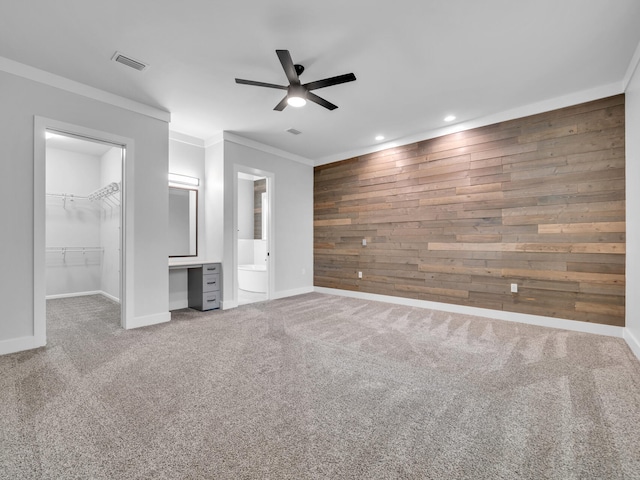 1160 Deer Moss Loop, Niceville, FL 32578 - unfurnished bedroom with carpet, visible vents, a walk in closet, wooden walls, and baseboards