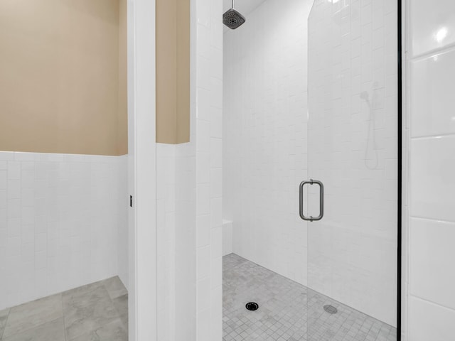 1160 Deer Moss Loop, Niceville, FL 32578 - bathroom with tile walls, a stall shower, and a wainscoted wall