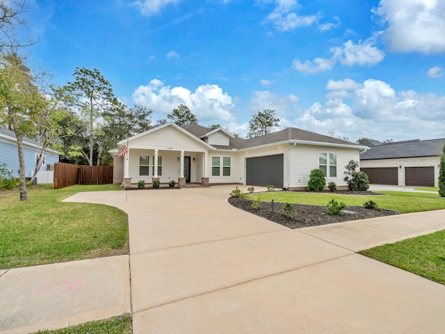 1160 Deer Moss Loop, Niceville, FL 32578 - ranch-style home with an attached garage, covered porch, fence, concrete driveway, and a front lawn