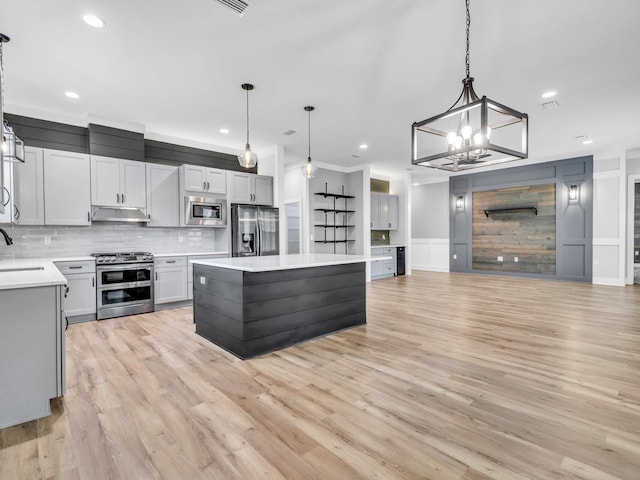 1160 Deer Moss Loop, Niceville, FL 32578 - kitchen featuring light countertops, under cabinet range hood, decorative backsplash, stainless steel appliances, and a sink