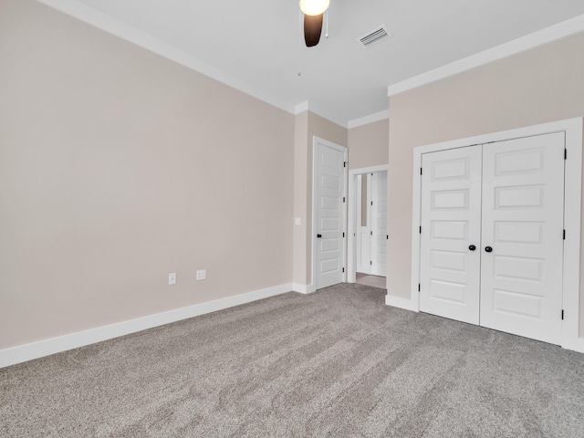 1160 Deer Moss Loop, Niceville, FL 32578 - unfurnished bedroom with a closet, baseboards, crown molding, visible vents, and carpet
