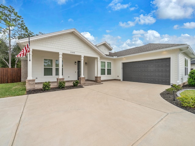 1160 Deer Moss Loop, Niceville, FL 32578 - view of front of home featuring driveway, a garage, fence, and covered porch