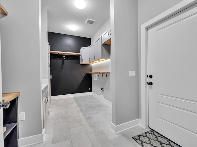 1160 Deer Moss Loop, Niceville, FL 32578 - laundry area featuring cabinet space, visible vents, baseboards, and electric dryer hookup