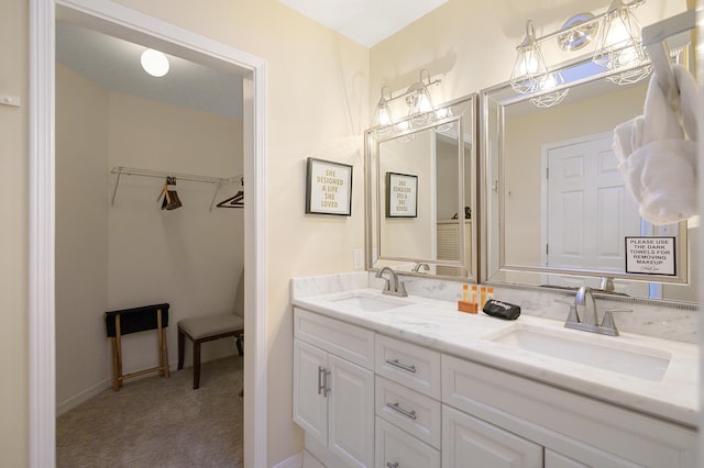 8855 Baypine Dr, Miramar Beach, FL 32550 - bathroom featuring double vanity, a spacious closet, and a sink