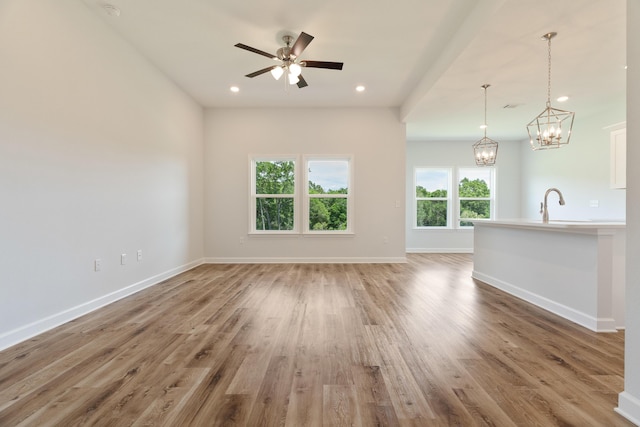 6117 Tansey St, Crestview, FL 32539 - unfurnished living room featuring light wood finished floors, a chandelier, baseboards, ceiling fan, and recessed lighting