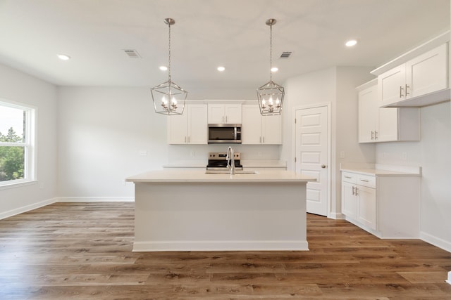 6117 Tansey St, Crestview, FL 32539 - kitchen with stainless steel microwave, a chandelier, a sink, baseboards, and light countertops