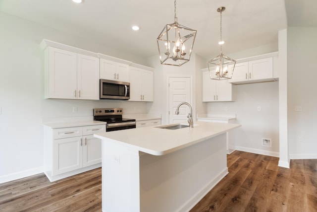 6117 Tansey St, Crestview, FL 32539 - kitchen featuring appliances with stainless steel finishes, a sink, a kitchen island with sink, a chandelier, and white cabinetry