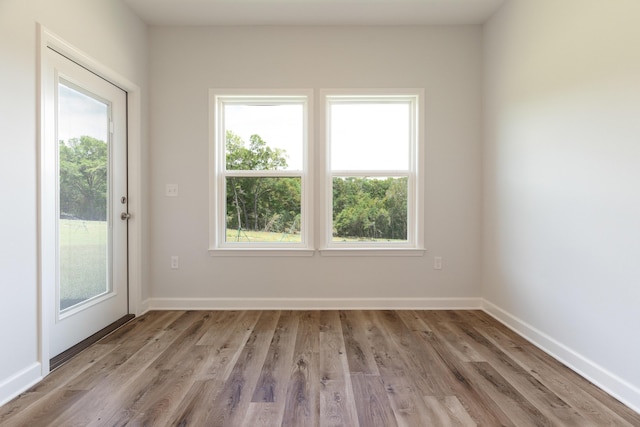 6117 Tansey St, Crestview, FL 32539 - empty room featuring healthy amount of natural light, light wood-style floors, and baseboards