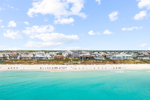 drone / aerial view with a beach view, a residential view, and a water view