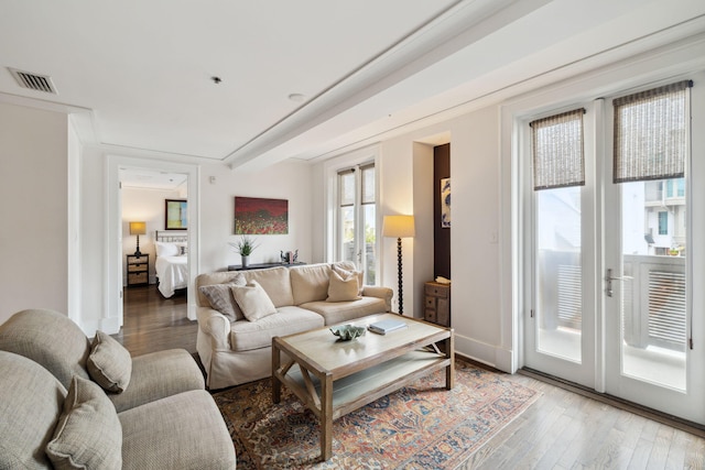 living room featuring visible vents and wood finished floors