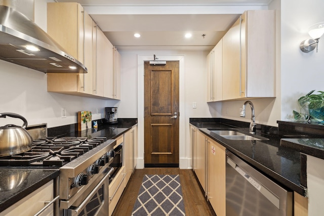 kitchen with island exhaust hood, dark stone countertops, dark wood-style floors, appliances with stainless steel finishes, and a sink