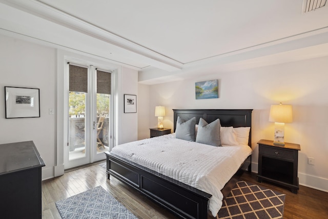 bedroom with visible vents, baseboards, access to outside, and wood finished floors