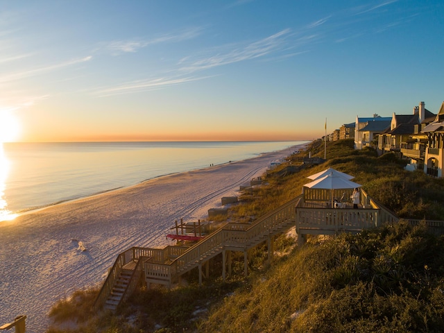 view of water feature featuring a view of the beach, a gazebo, and stairway