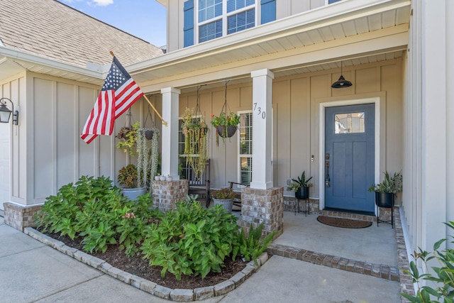 730 Cornelia St, Freeport, FL 32439 - property entrance with board and batten siding, a porch, and a shingled roof