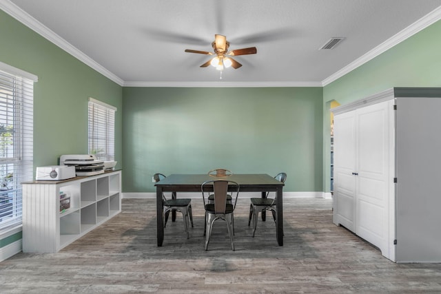 730 Cornelia St, Freeport, FL 32439 - dining area with ceiling fan, ornamental molding, wood finished floors, and baseboards