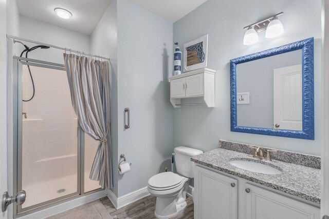 730 Cornelia St, Freeport, FL 32439 - bathroom featuring a stall shower, baseboards, toilet, and wood finished floors