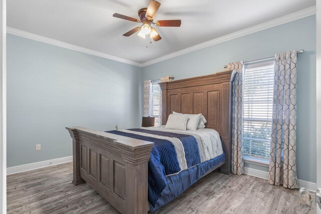 730 Cornelia St, Freeport, FL 32439 - bedroom featuring wood finished floors, multiple windows, baseboards, ornamental molding, and ceiling fan