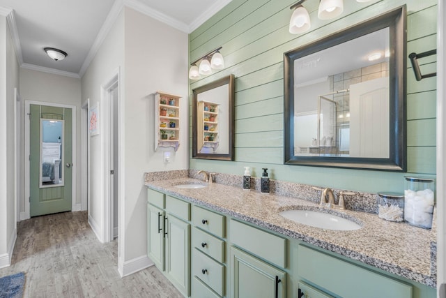 730 Cornelia St, Freeport, FL 32439 - bathroom featuring a stall shower, crown molding, wood finished floors, baseboards, and double vanity