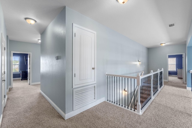 730 Cornelia St, Freeport, FL 32439 - hall with an upstairs landing, carpet flooring, and baseboards
