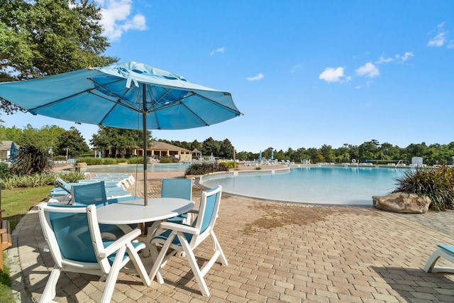 730 Cornelia St, Freeport, FL 32439 - community pool with a patio and outdoor dining space