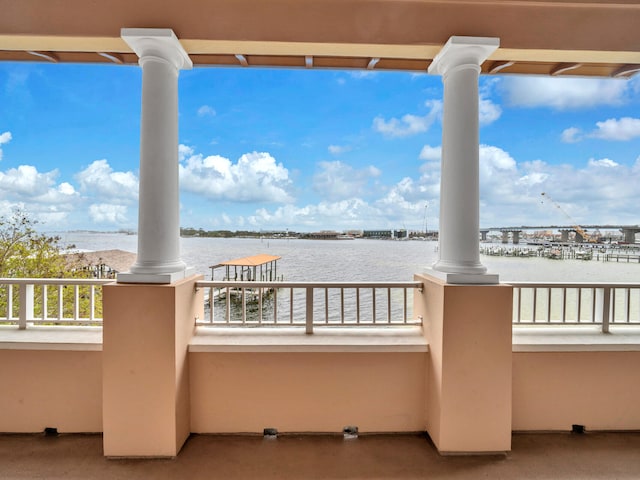 view of patio with a water view and a balcony