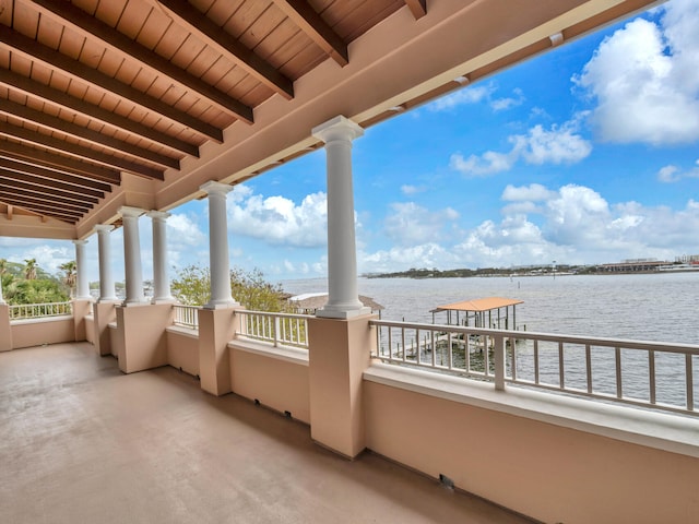 view of patio / terrace with a balcony and a water view