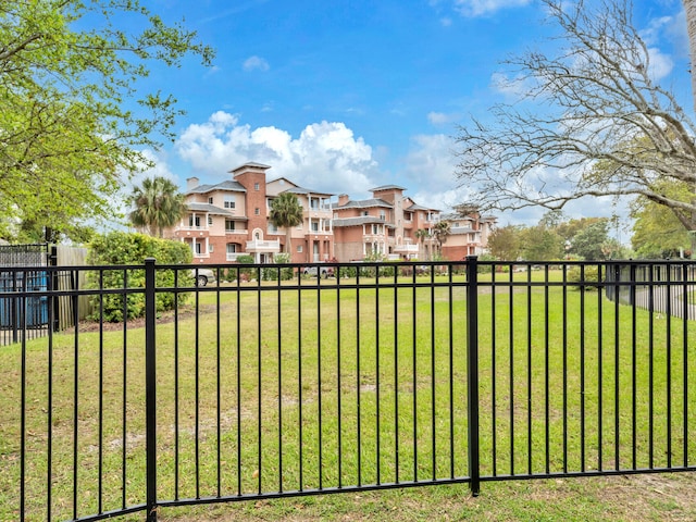 view of yard featuring a residential view and fence