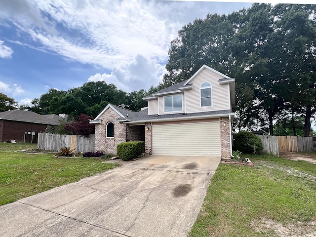 view of front facade featuring a front lawn, fence, brick siding, an attached garage, and driveway