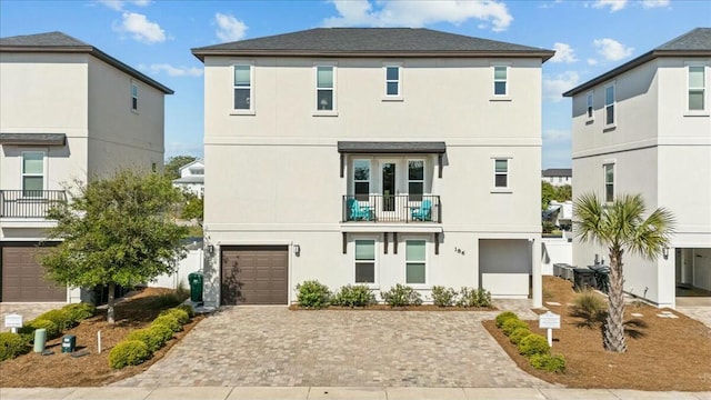 186 Ciboney St, Miramar Beach, FL 32550 - view of front of property featuring a balcony, a garage, stucco siding, and decorative driveway