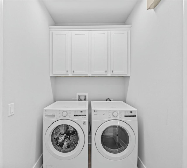 186 Ciboney St, Miramar Beach, FL 32550 - clothes washing area featuring washing machine and clothes dryer, baseboards, and cabinet space