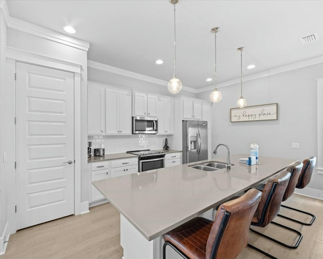 186 Ciboney St, Miramar Beach, FL 32550 - kitchen featuring light wood finished floors, visible vents, a sink, and appliances with stainless steel finishes