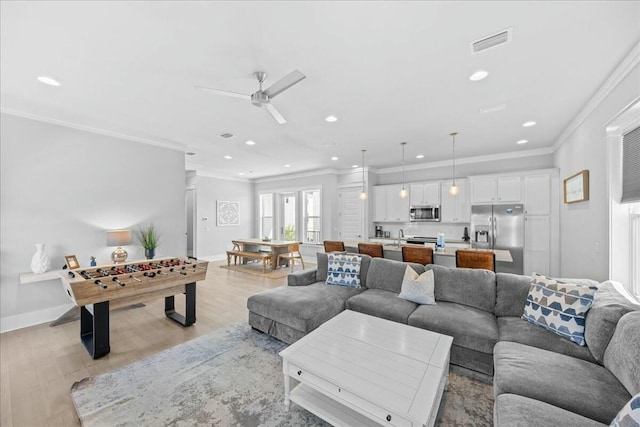 186 Ciboney St, Miramar Beach, FL 32550 - living area with recessed lighting, visible vents, light wood-type flooring, and crown molding