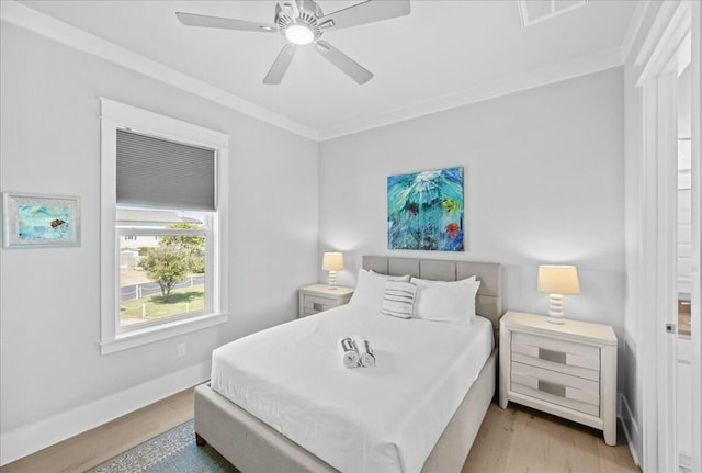 186 Ciboney St, Miramar Beach, FL 32550 - bedroom with baseboards, ornamental molding, visible vents, ceiling fan, and wood finished floors