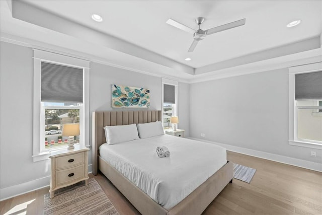 186 Ciboney St, Miramar Beach, FL 32550 - bedroom with a tray ceiling, wood finished floors, and baseboards