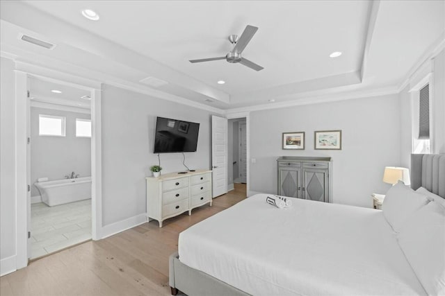 186 Ciboney St, Miramar Beach, FL 32550 - bedroom with light wood-style floors, recessed lighting, visible vents, and a tray ceiling