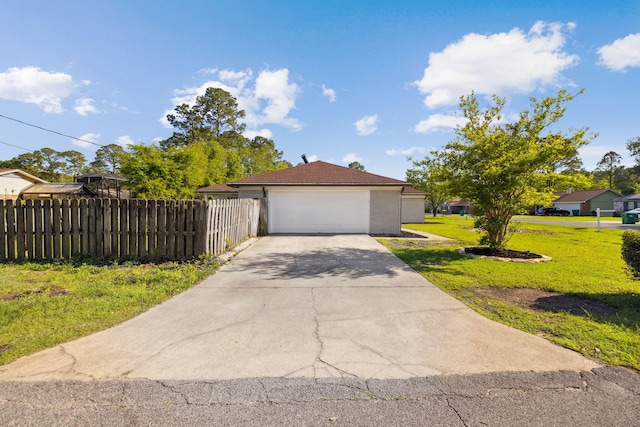 view of front of property with driveway, a garage, fence, and a front lawn