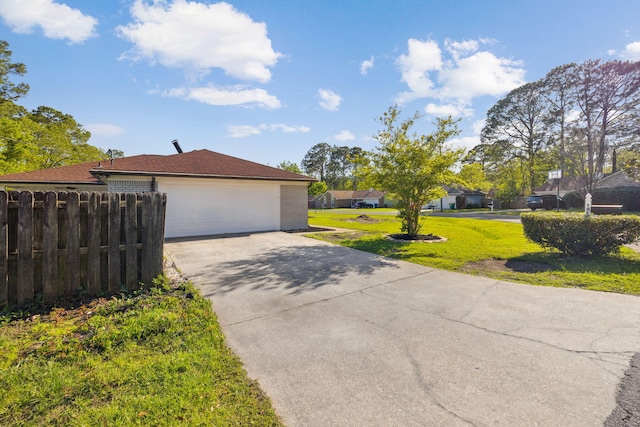 exterior space featuring fence and driveway