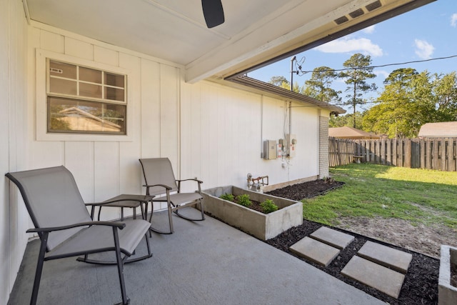 view of patio featuring a garden and fence