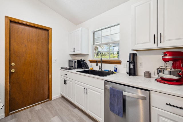 kitchen featuring light wood-style floors, dishwasher, white cabinetry, and a sink