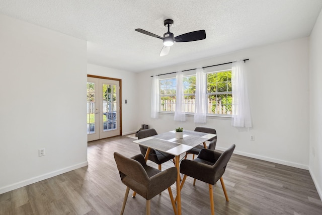 dining area featuring french doors, baseboards, a ceiling fan, and wood finished floors
