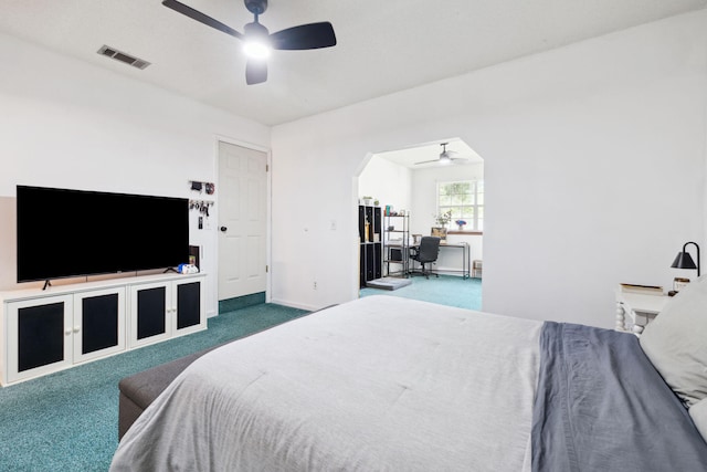 carpeted bedroom featuring visible vents, baseboards, a ceiling fan, and arched walkways