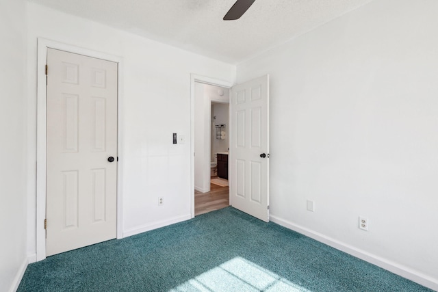 unfurnished bedroom featuring carpet, baseboards, and ceiling fan