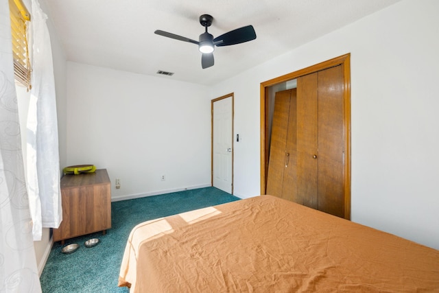 bedroom with a closet, baseboards, carpet flooring, visible vents, and ceiling fan