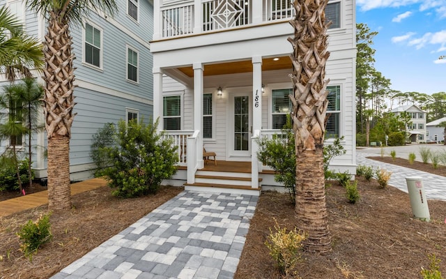 entrance to property with a porch and a balcony