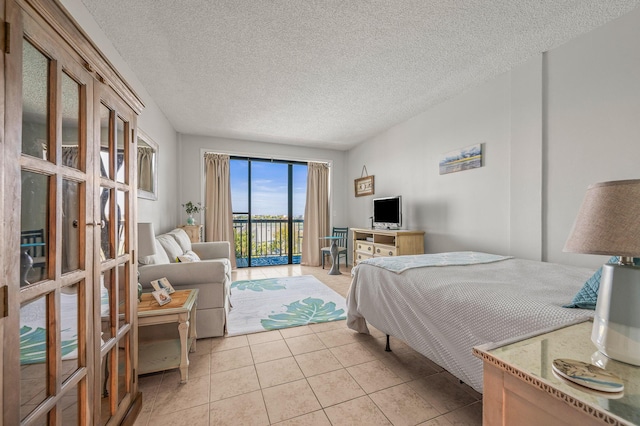 bedroom featuring french doors, access to exterior, a textured ceiling, and light tile patterned flooring