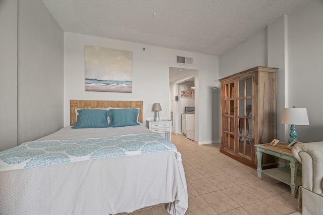 bedroom with visible vents, a textured ceiling, and light tile patterned flooring