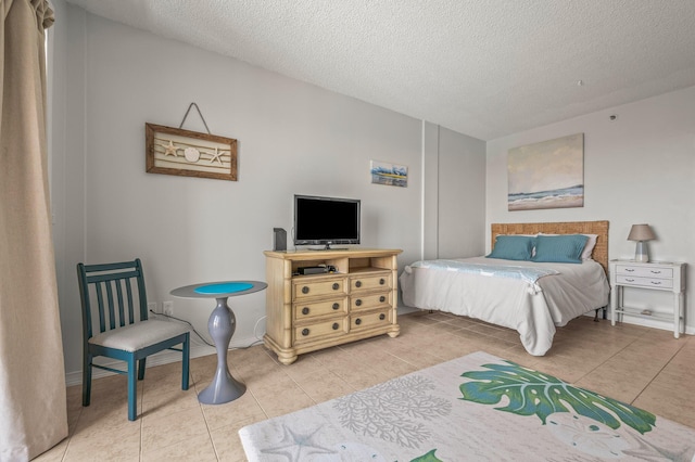 tiled bedroom featuring a textured ceiling