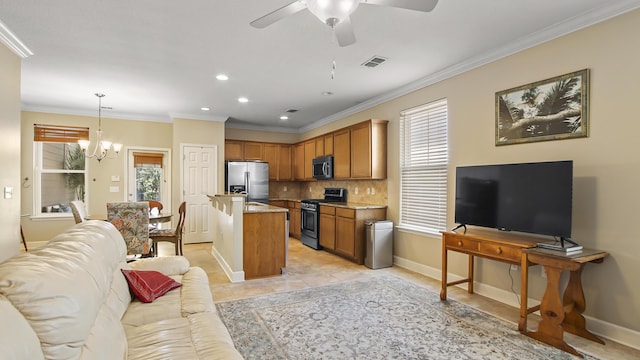 317 Turtle Cv, Panama City Beach, FL 32413 - kitchen featuring visible vents, ornamental molding, open floor plan, ceiling fan with notable chandelier, and stainless steel appliances