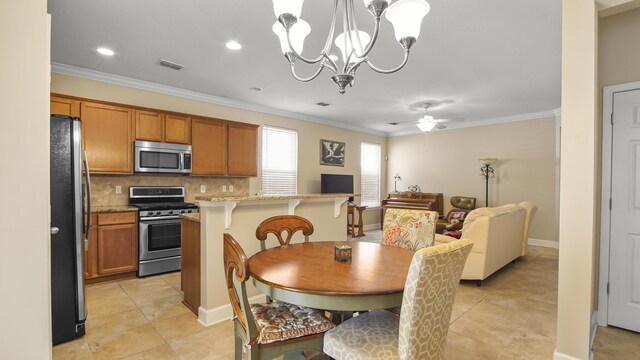 317 Turtle Cv, Panama City Beach, FL 32413 - dining room with crown molding, visible vents, light tile patterned flooring, and ceiling fan with notable chandelier