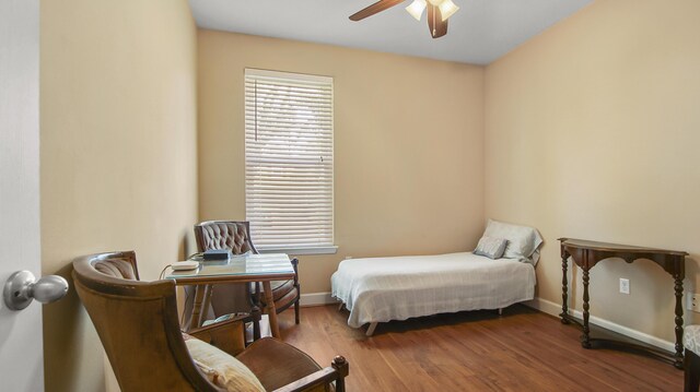 317 Turtle Cv, Panama City Beach, FL 32413 - bedroom with baseboards, a ceiling fan, and wood finished floors